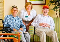 What we do section image: A group photo of elderly people smiling with Staff.